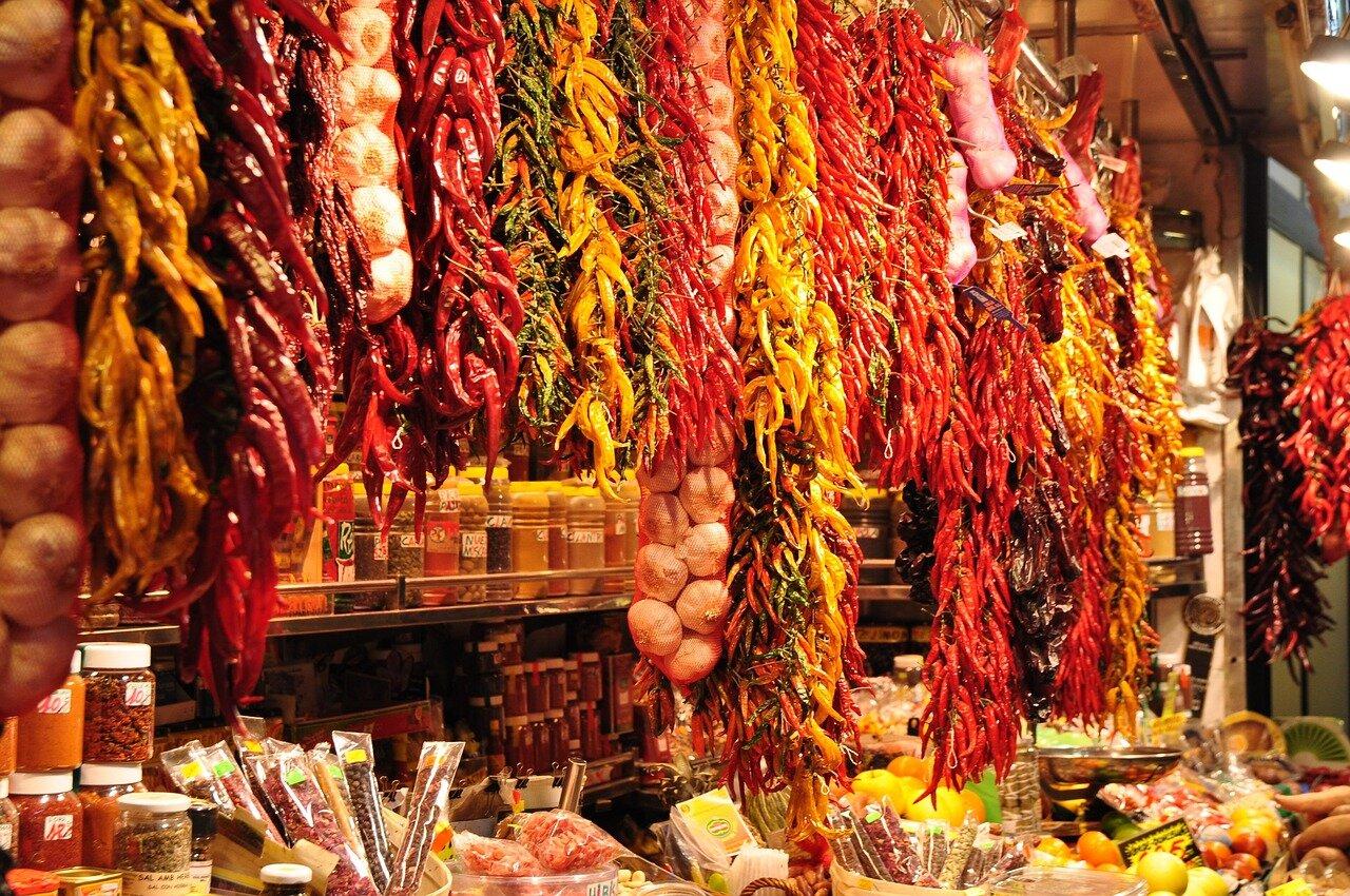 Shoppers waiting at a fish counter inside a covered Catalan market